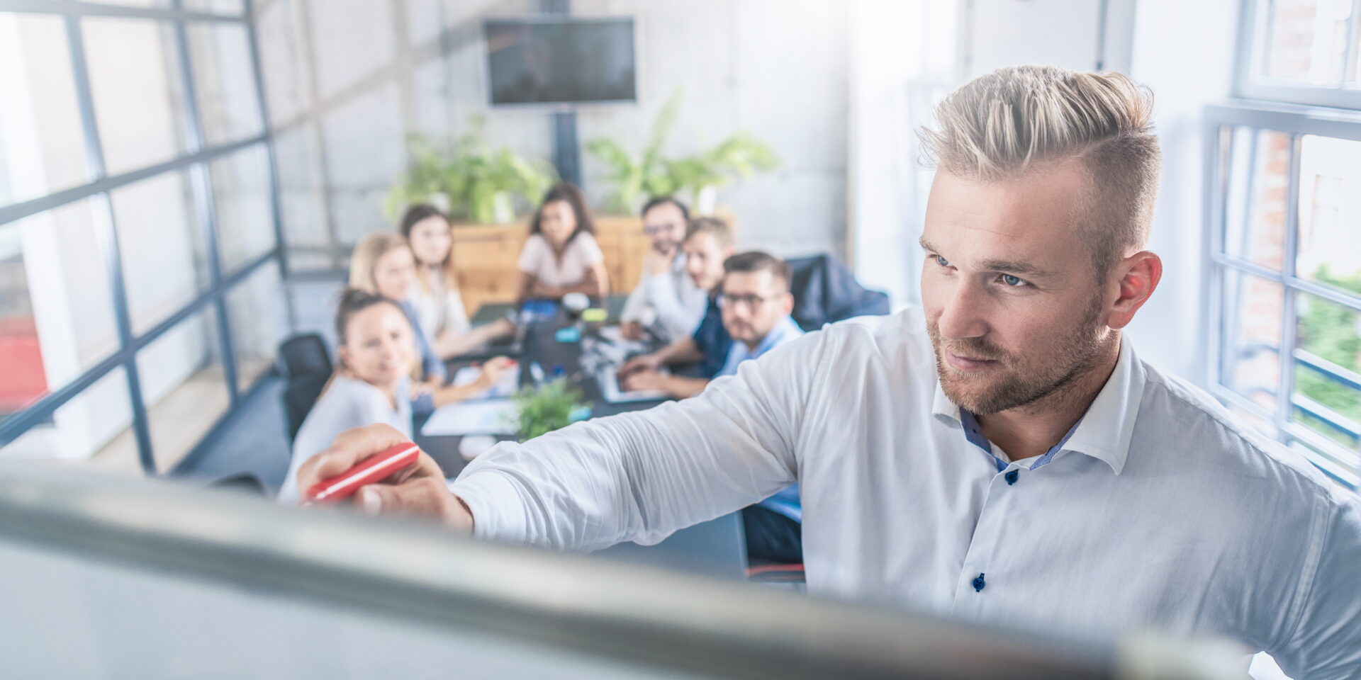 Business coach. Team leader teaches employees at a business meeting in a conference room.