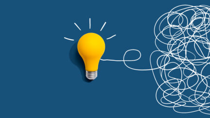 Clarifying complex ideas theme with light bulb - Flat lay